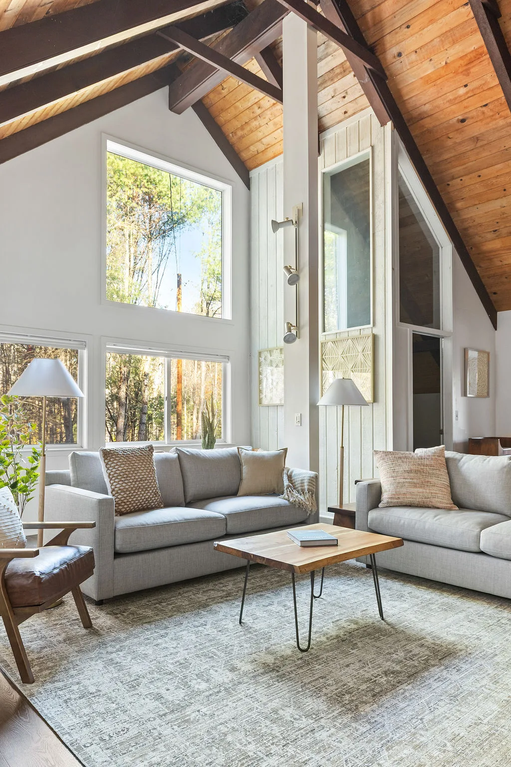 The great room with cathedral ceilings and forest views