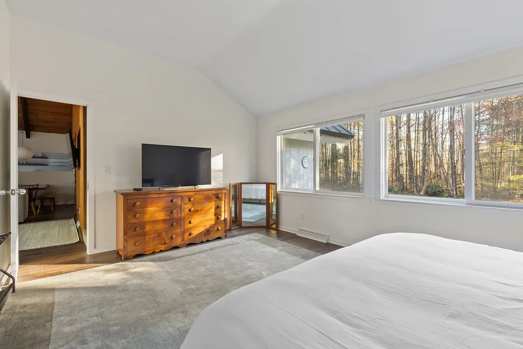 The primary bedroom with forest views